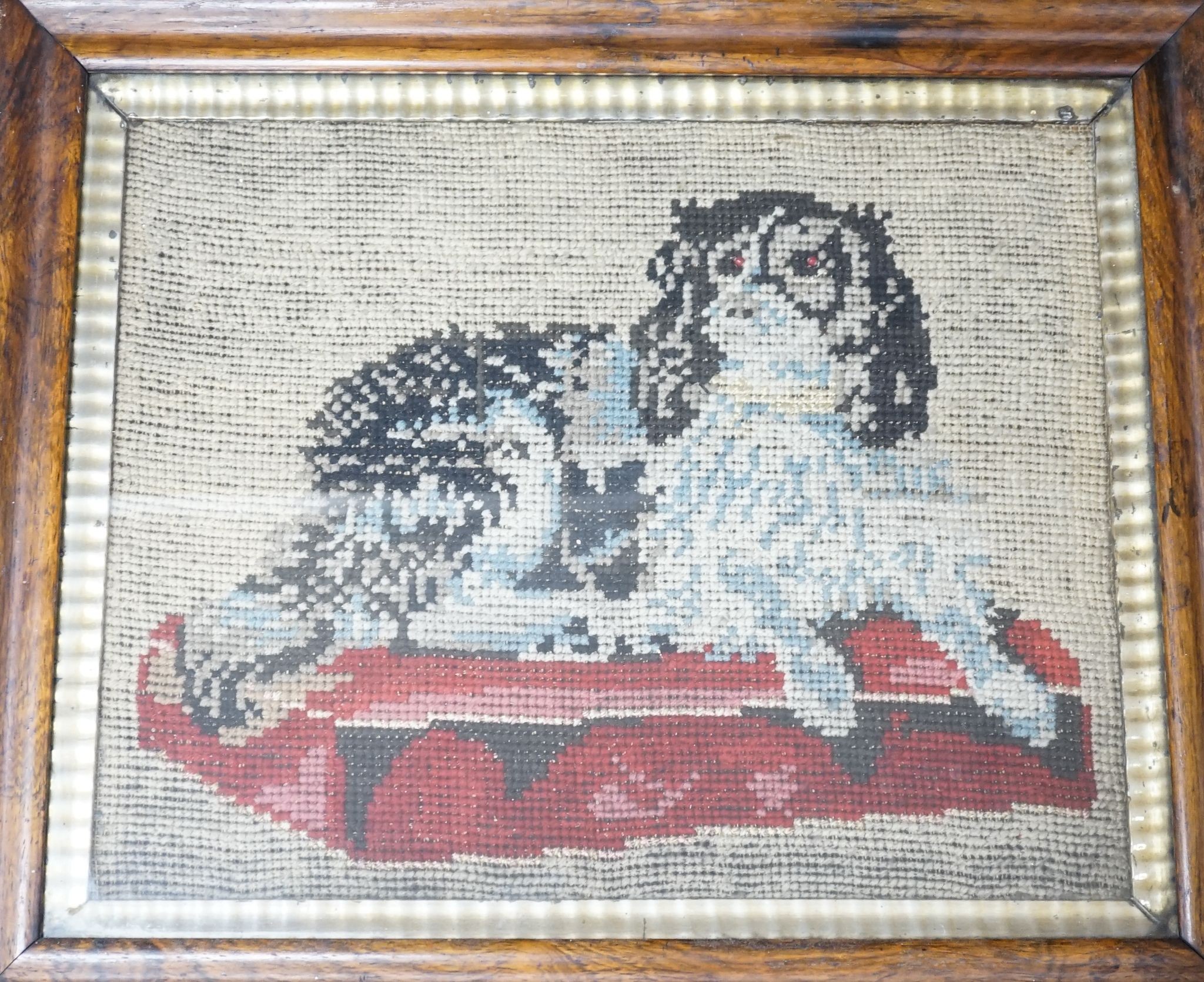 A framed Victorian needlework panel of a spaniel 30x37cm excl. frame